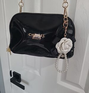 Black Patent Crossbody Bag with Floral Charm CHANEL BEAUTE